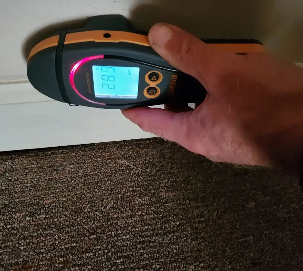 Moisture detection at baseboard during Storm Damage Restoration in Havre